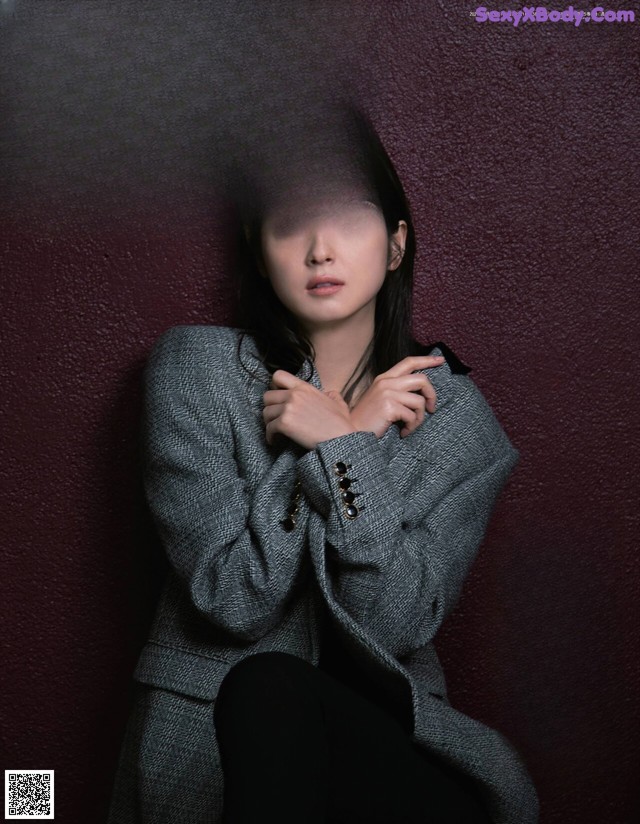 A woman sitting on the cover of a magazine.
