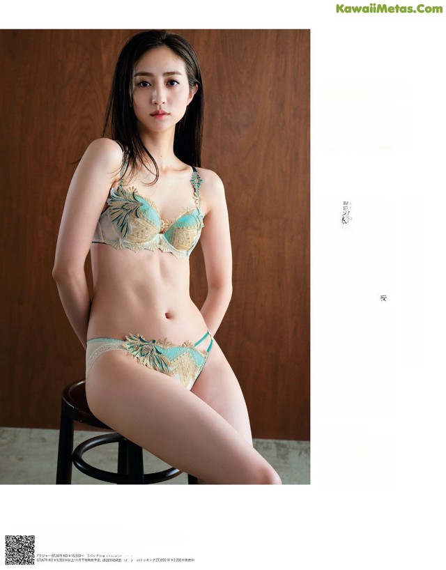 A woman in a bikini sitting on a stool.