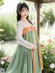 a woman in a green and orange hanbok